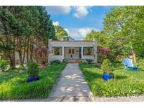 Charming bungalow with landscaped front yard and inviting walkway to the front porch at 1822 Hall Ave, Charlotte, NC 28205