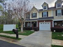 Charming townhome with a well-maintained lawn, a one car garage, and a welcoming front entrance at 2026 Talbot Ln, Hickory, NC 28602