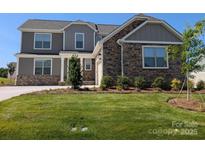 Charming two-story home with stone accents, grey siding, manicured lawn, and well-maintained landscaping at 2075 Fordhill St, Rock Hill, SC 29732