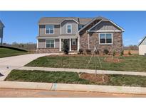 Beautiful two-story home featuring a stone and gray siding exterior and a well-manicured lawn at 2075 Fordhill St, Rock Hill, SC 29732