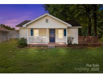 Charming single-story home featuring a welcoming front porch, lush lawn, and well-maintained landscaping at 2729 S Ridge Ave, Concord, NC 28025