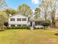 Charming two-story home featuring a freshly manicured lawn and beautiful landscaping at 2816 Eastport Rd, Charlotte, NC 28205