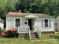 A quaint single-story home with an inviting front porch and mature landscaping at 315 Broad Sw Dr, Concord, NC 28025