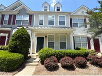 Charming townhouse featuring neutral siding, dormer windows, well-maintained landscaping, and a welcoming front entrance at 3527 Creeping Flora Ln, Charlotte, NC 28216