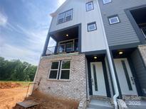 Contemporary townhome showcases a brick foundation and a mix of light and dark siding at 408 Nathaniel Way # Brx0053, Charlotte, NC 28213