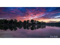 Beautiful lakefront property with stunning sunset view and serene water reflection at 4599 B & C Dr, Catawba, NC 28609