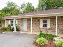 Charming brick home featuring a covered porch and well-maintained landscaping at 505 2Nd Street Ne Pl # B2, Conover, NC 28613