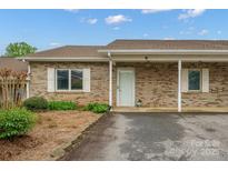 Charming brick home featuring a covered porch and well-manicured landscaping at 505 2Nd Street Ne Pl # B2, Conover, NC 28613