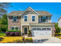 Charming two-story home featuring a stone facade and a well-manicured lawn at 5070 Saint Clair St, Fort Mill, SC 29715