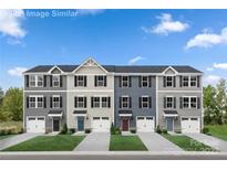 Beautiful new construction townhomes with manicured lawns and individual garages offer a modern design and curb appeal at 5782 Knox Ln, Kannapolis, NC 28081