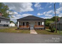 Charming home with a inviting front porch with a black roof, and landscaped front yard at 62 Fourth St, Cramerton, NC 28032
