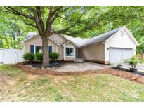 Charming single-story home featuring a well-manicured front yard and cozy entryway bench at 6736 Raeburn Ln, Charlotte, NC 28227
