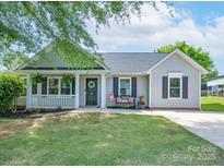 Charming single story home with a well manicured lawn, covered porch, and inviting curb appeal at 744 Chipmeadow Ln, York, SC 29745