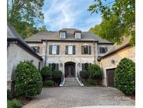 Elegant two-story home featuring a symmetrical facade, dormer windows, and manicured landscaping at 7906 Skye Lochs Dr, Waxhaw, NC 28173