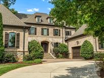 Inviting two-story home featuring manicured landscaping, a curved driveway, and an attached two-car garage at 7906 Skye Lochs Dr, Waxhaw, NC 28173