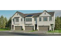Newly constructed townhomes with modern farmhouse design, featuring attached garages and a well maintained lawn at 808 Garringer Pl, Charlotte, NC 28208