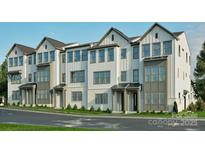New construction townhomes boast a modern facade with white siding, brick accents, and complementary gray trim at 817 Garringer Pl, Charlotte, NC 28208
