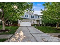 Charming two-story home features a well-maintained lawn and a two-car garage at 9414 Seamill Rd, Charlotte, NC 28278