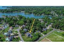 Expansive waterfront home with mature trees and lush landscaping along the shores of Lake Norman at 106 Chatworth Ln, Mooresville, NC 28117
