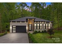 Charming brick home featuring a modern garage, landscaped yard, and inviting entryway at 1534 Easy St, Belmont, NC 28012