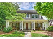 Charming two-story home featuring a welcoming front porch with stately columns and a meticulously maintained lawn at 2126 Norton Rd, Charlotte, NC 28207