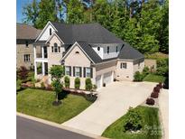 Stunning two-story home boasting a landscaped front yard and a spacious driveway leading to a two-car garage at 218 Turtleback Rdg, Matthews, NC 28104