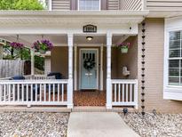Inviting front porch with decorative hanging plants and a charming, painted front door at 2804 Park Rd, Charlotte, NC 28209