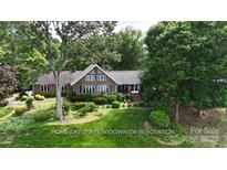Charming single-Gathering home featuring a well-maintained lawn and mature landscaping at 2818 Cherry Ln, Denver, NC 28037