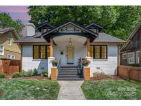 Charming renovated two-story home featuring a freshly painted white brick exterior and inviting front porch at 624 Oakland Ave, Charlotte, NC 28204