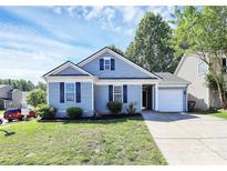 Charming single-story home with a well-manicured lawn and attached one car garage at 9212 Scotts Elm Ct, Charlotte, NC 28215