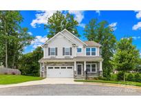 Charming two-story home with stone accents, a two-car garage, and a well-maintained front yard at 106 Kirsche Ct, Mooresville, NC 28115