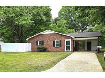 Charming single-story brick home featuring a well-manicured lawn and a convenient carport at 11 N 10Th Ave, Maiden, NC 28650