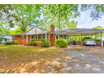 Charming brick home with a carport and mature trees providing shade at 191 Scenic Ne Dr, Concord, NC 28025