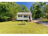 Charming single-story home with white siding, black shutters, and a well-maintained lawn at 201 Trinity St, Clover, SC 29710