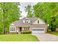 Charming home with a two-car garage, covered front porch, well-manicured lawn, and lush landscaping at 2345 Sparrow Dr, Rock Hill, SC 29732