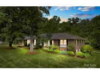 Charming brick home with mature trees and landscaping at 2410 Armstrong Park Dr, Gastonia, NC 28054