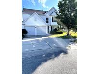 Charming two-story home featuring a two-car garage and a well-manicured front yard at 3038 Old Ironside Dr, Charlotte, NC 28213