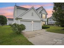 Charming two-story home featuring a two-car garage and manicured landscaping at 3038 Old Ironside Dr, Charlotte, NC 28213