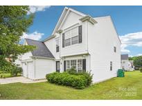 Charming two-story home featuring white siding, black shutters, and a well-maintained front lawn at 3038 Old Ironside Dr, Charlotte, NC 28213