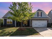 Charming home featuring manicured lawn, stone accents, attached garage, and mature landscaping at 3267 Lock Erne Ave, Kannapolis, NC 28081
