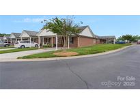 Attractive brick home featuring a covered carport and well-manicured lawn at 3951 Jasmine Ln, Denver, NC 28037