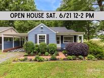 Charming blue home featuring an open house sign, landscaped front yard, and inviting entrance at 430 Sells Rd, Salisbury, NC 28144