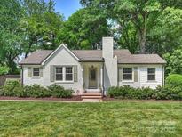Charming exterior view of a well-manicured home with lush green lawn and landscaping at 4921 Doris Ave, Charlotte, NC 28205