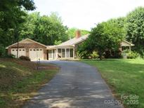 Charming single-story brick home featuring an attached two-car garage and a well-manicured front lawn at 5908 Tanson Trl, Marshville, NC 28103