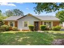 Charming single-story home with brick and siding exterior, manicured bushes, and a well-kept lawn at 728 Dedmon Dr, Charlotte, NC 28216