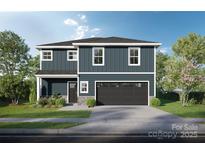 Charming two-story home featuring a well-manicured lawn, gray siding, and an attached two-car garage at Lot 39 Swallow Tail Ln, Kannapolis, NC 28083