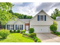 Charming two-story home featuring a well-maintained lawn, white siding, and blue shutters at 1301 Cool Mist Ct, Indian Land, SC 29707