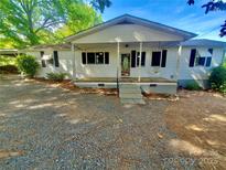 Charming single-story home with a covered front porch and ample parking at 16603 Nc Hwy 73 Hwy, Albemarle, NC 28001