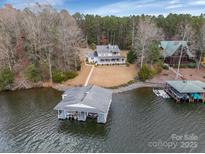 Stunning lakefront property with a private boathouse and beautifully landscaped grounds at 192 Diana Dr, Mount Gilead, NC 27306