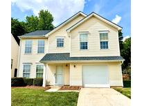 Charming yellow two-story home with a well-manicured lawn and attached one car garage at 3032 Mallard Forest Dr, Charlotte, NC 28269